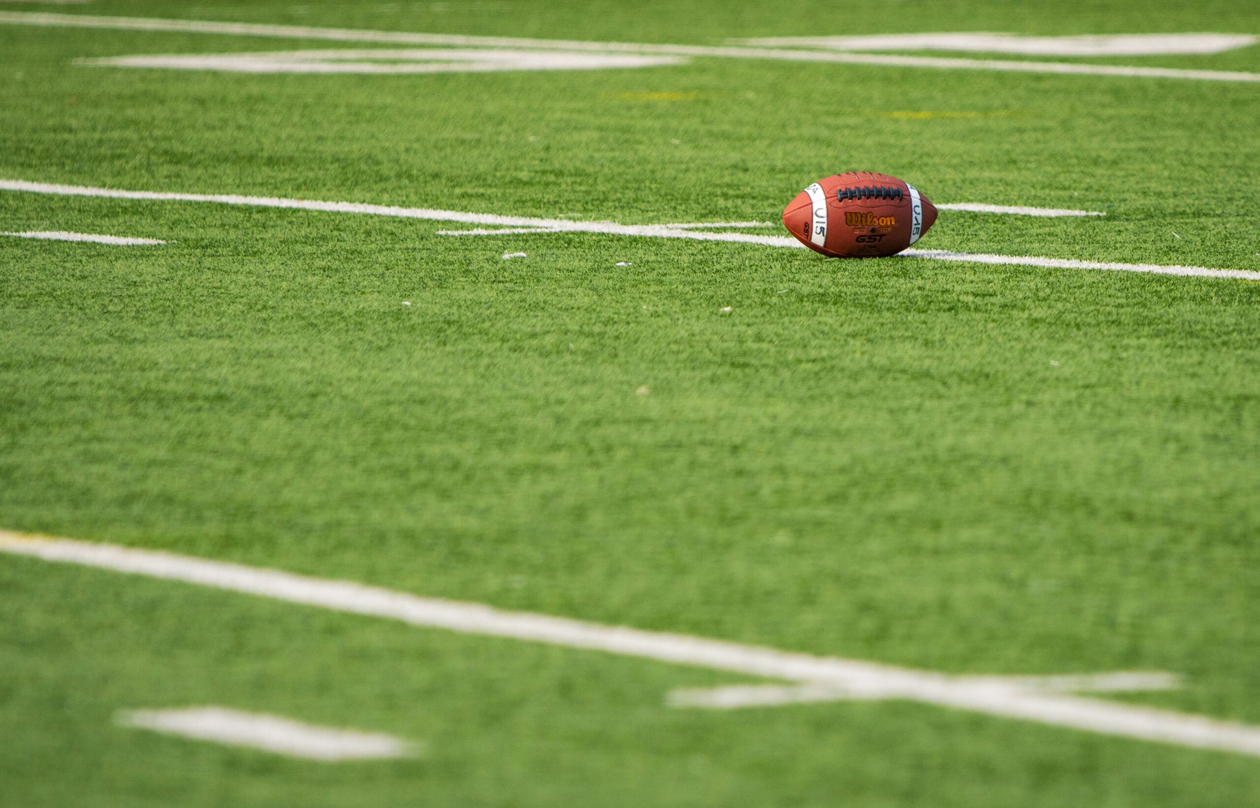 Photo of a football on a football field.